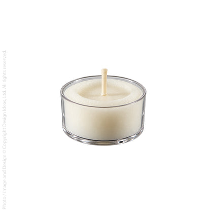 Single white tealight candle in a clear cup